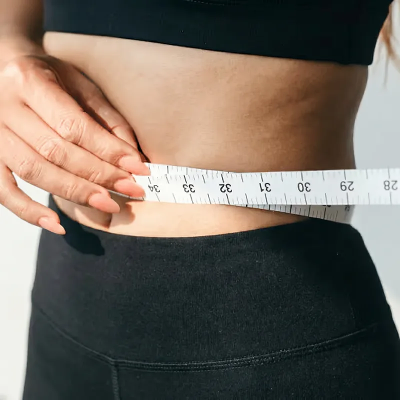 Measuring tape around a waistline